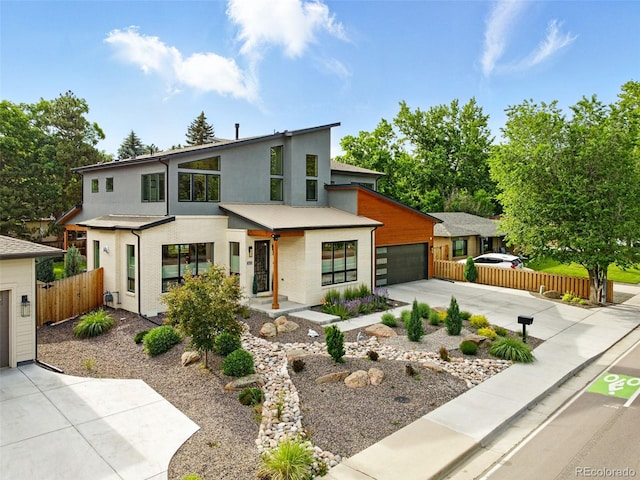 2635 Pierce St, Wheat Ridge, CO 80214 - contemporary home with stucco siding, concrete driveway, and an attached garage