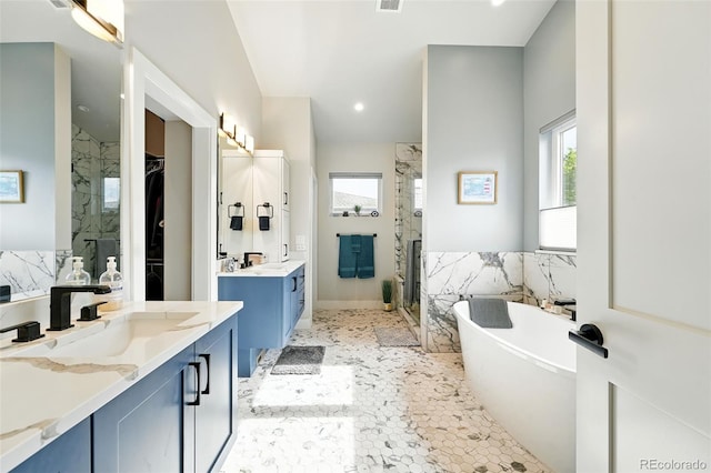 2635 Pierce St, Wheat Ridge, CO 80214 - bathroom with a marble finish shower, two vanities, and a freestanding bath