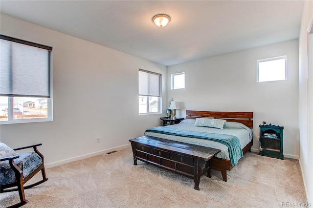 carpeted bedroom with multiple windows