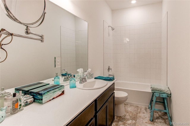 full bathroom with vanity, toilet, and tiled shower / bath