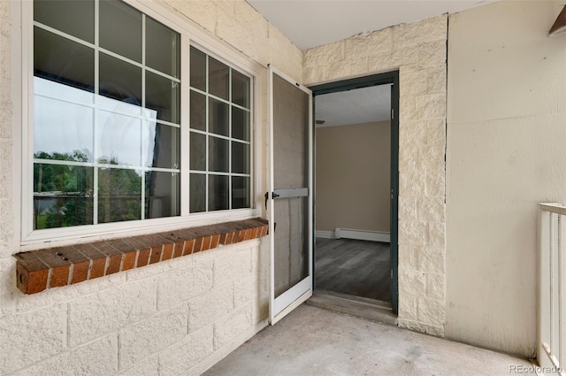 view of exterior entry featuring a baseboard heating unit