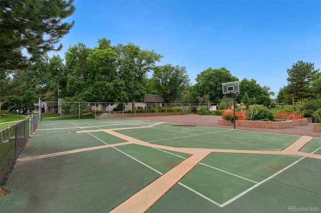 view of home's community featuring tennis court