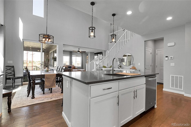 4781 Basalt Ridge Cir, Castle Rock, CO 80108 - kitchen featuring dark countertops, dark wood-style floors, dishwasher, a ceiling fan, and a high ceiling