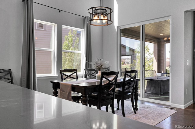 4781 Basalt Ridge Cir, Castle Rock, CO 80108 - dining space with a chandelier, wood finished floors, and baseboards