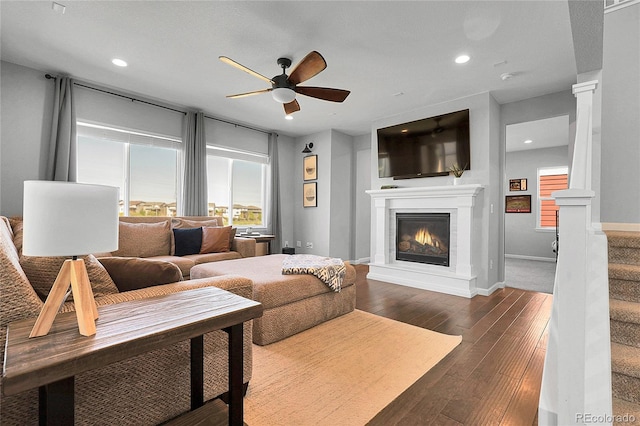 4781 Basalt Ridge Cir, Castle Rock, CO 80108 - living area with ceiling fan, a glass covered fireplace, recessed lighting, decorative columns, and dark wood finished floors