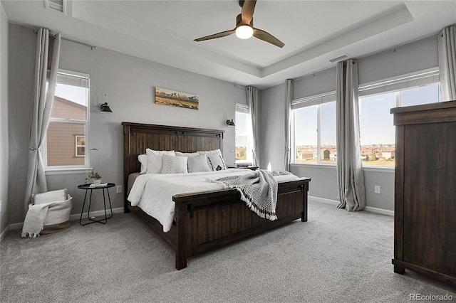 4781 Basalt Ridge Cir, Castle Rock, CO 80108 - bedroom with a tray ceiling, light colored carpet, multiple windows, and baseboards
