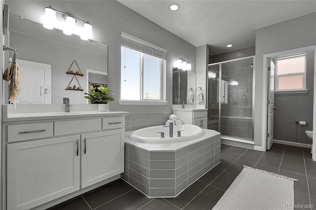 4781 Basalt Ridge Cir, Castle Rock, CO 80108 - bathroom with a shower stall, tile patterned flooring, two vanities, toilet, and recessed lighting