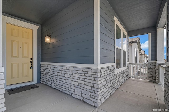 13392 E 110th Way, Commerce City, CO 80022 - property entrance featuring covered porch and stone siding