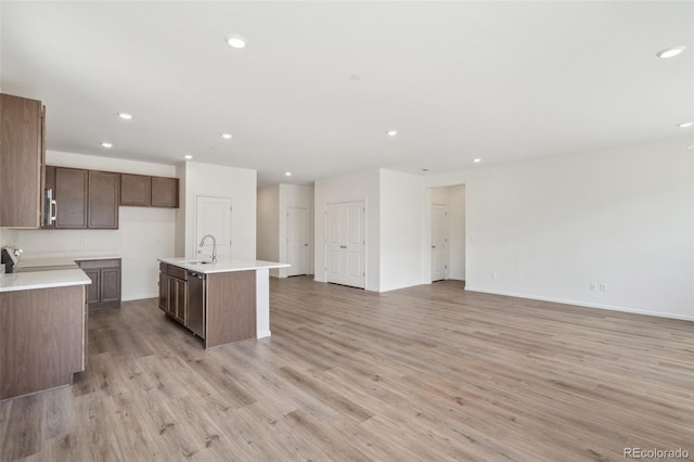 13392 E 110th Way, Commerce City, CO 80022 - kitchen featuring light wood-style floors, recessed lighting, a sink, open floor plan, and light countertops