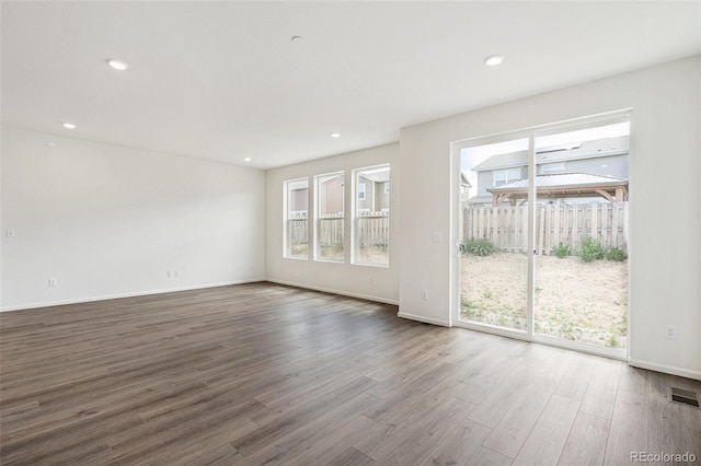 13392 E 110th Way, Commerce City, CO 80022 - unfurnished room with dark wood-style floors, plenty of natural light, baseboards, and recessed lighting