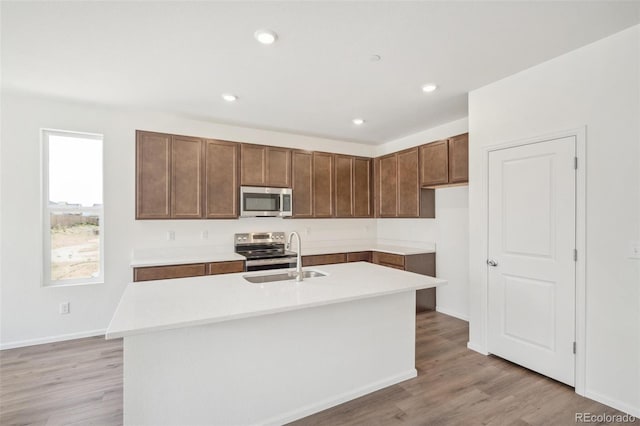 13392 E 110th Way, Commerce City, CO 80022 - kitchen with stainless steel appliances, a sink, light wood-type flooring, light countertops, and recessed lighting