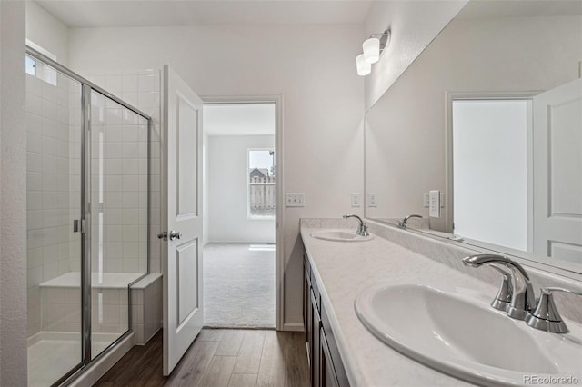 13392 E 110th Way, Commerce City, CO 80022 - bathroom featuring wood finished floors, a stall shower, and double vanity