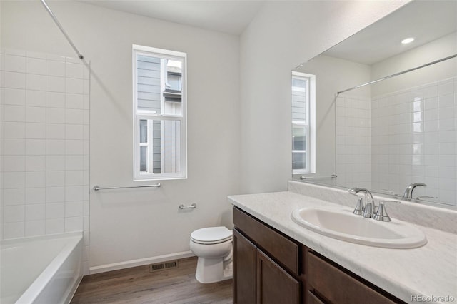13392 E 110th Way, Commerce City, CO 80022 - bathroom featuring wood finished floors, toilet, vanity,  shower combination, and baseboards