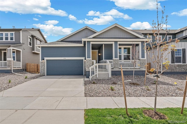 13392 E 110th Way, Commerce City, CO 80022 - view of front of house with a porch, stone siding, a garage, concrete driveway, and board and batten siding