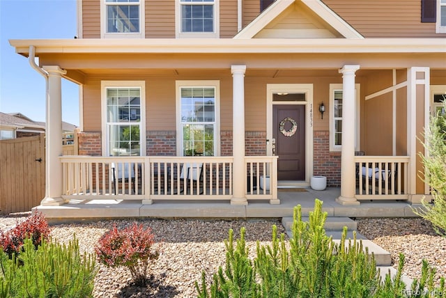 14833 E Crestridge Dr, Centennial, CO 80015 - doorway to property with covered porch and brick siding