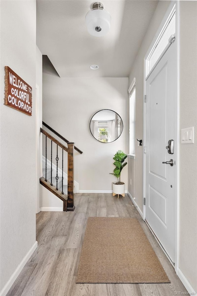 14833 E Crestridge Dr, Centennial, CO 80015 - foyer entrance with stairway, wood finished floors, and baseboards