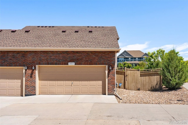 14833 E Crestridge Dr, Centennial, CO 80015 - view of property exterior with brick siding, roof with shingles, a garage, and driveway
