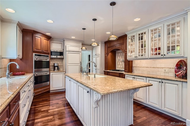 10130 E Powers Ave, Greenwood Village, CO 80111 - kitchen with appliances with stainless steel finishes, decorative backsplash, dark wood-style flooring, glass insert cabinets, and recessed lighting