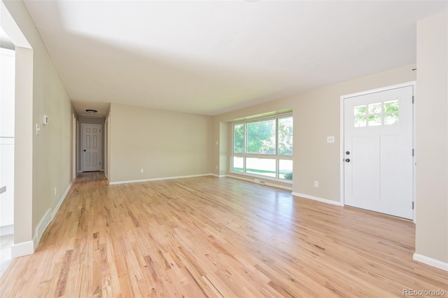 unfurnished living room featuring light hardwood / wood-style flooring and a wealth of natural light