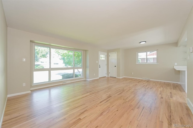 unfurnished room featuring light hardwood / wood-style flooring and a wealth of natural light