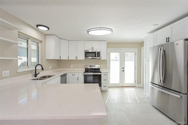 kitchen with white cabinetry, stainless steel appliances, and a wealth of natural light