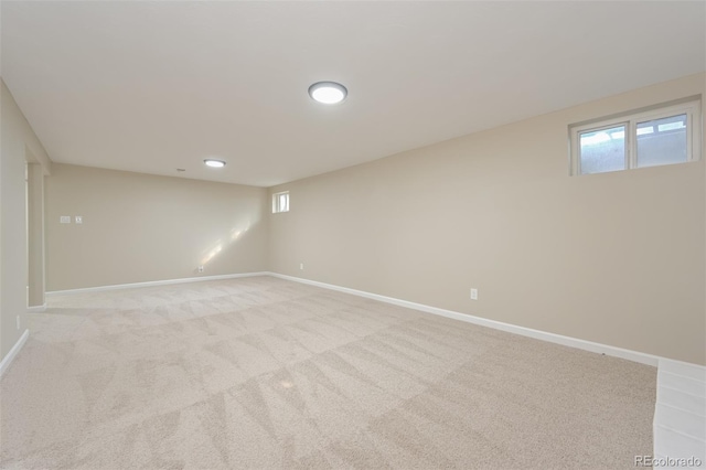 basement featuring light carpet