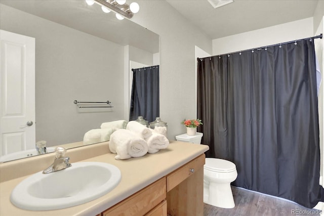 13271 Holly St Unit B, Thornton, CO 80241 - full bathroom featuring vanity, wood finished floors, and a shower with curtain