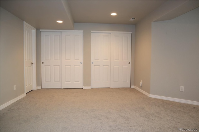 13271 Holly St Unit B, Thornton, CO 80241 - unfurnished bedroom with recessed lighting, two closets, and carpet floors