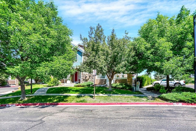 13271 Holly St Unit B, Thornton, CO 80241 - view of property hidden behind natural elements featuring a front lawn