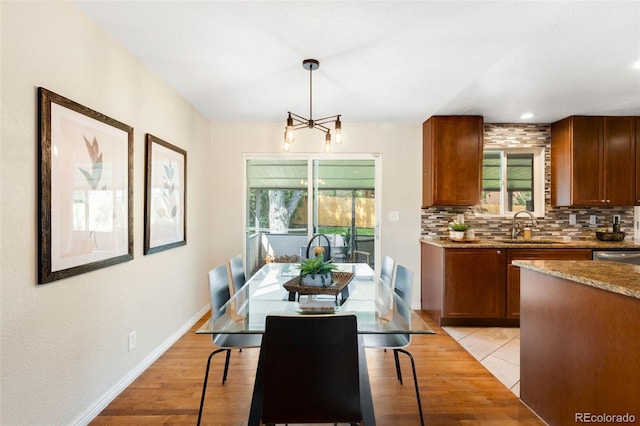 9325 Meade St, Westminster, CO 80031 - dining space with light wood-style floors and a chandelier