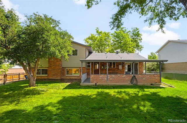 9325 Meade St, Westminster, CO 80031 - back of property with a fenced backyard, brick siding, and a patio