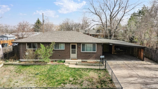 ranch-style house featuring a front lawn and a carport