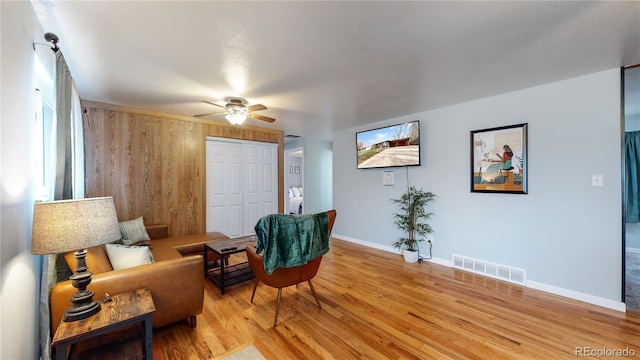 living area featuring ceiling fan and light hardwood / wood-style floors