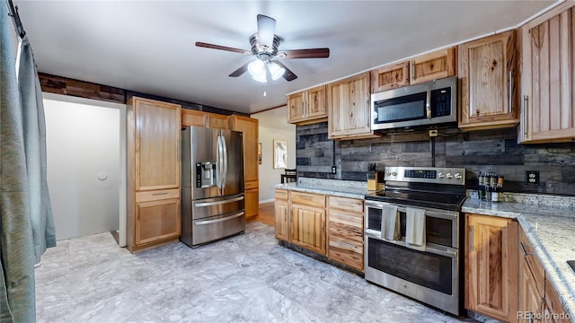 kitchen featuring decorative backsplash, light stone countertops, ceiling fan, and appliances with stainless steel finishes