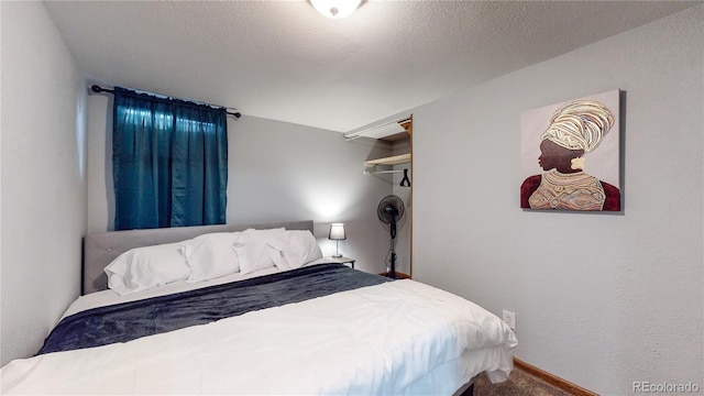 bedroom featuring carpet floors and a textured ceiling