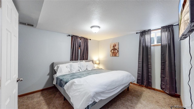 carpeted bedroom with a textured ceiling