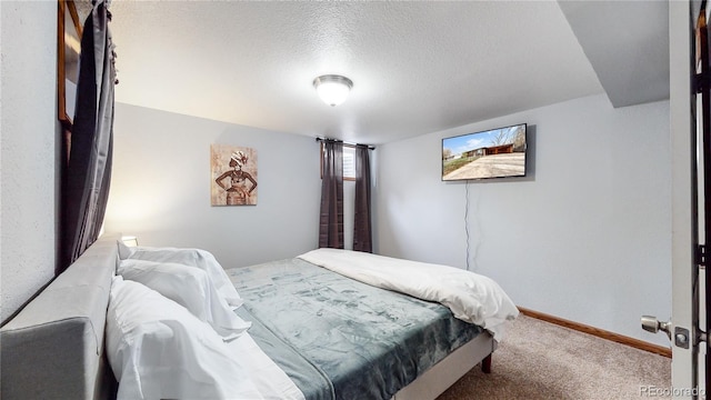 bedroom with carpet and a textured ceiling