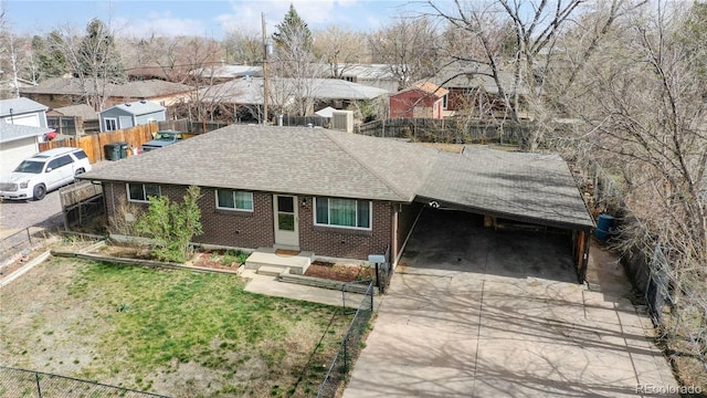 ranch-style home with a carport and a front yard