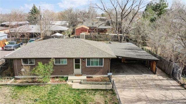 ranch-style home featuring a carport and cooling unit