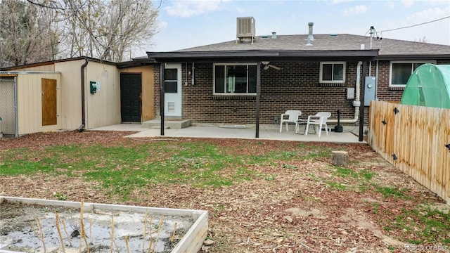 back of house with a yard, a patio, and central air condition unit