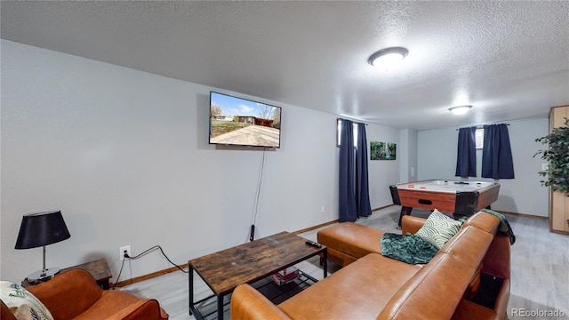 1242 Elder St, Denver, CO 80221 - living area with a textured ceiling, light wood-style floors, and baseboards