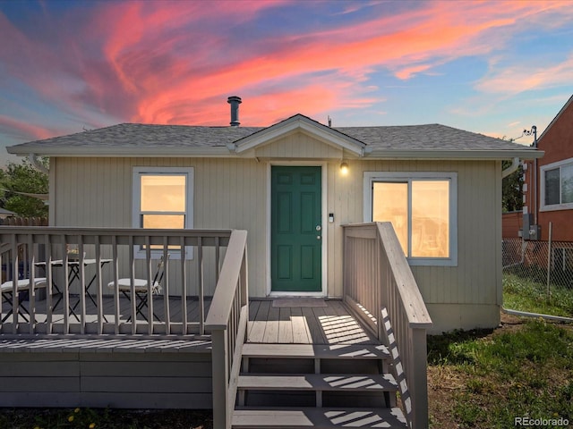 3134 W Center Ave, Denver, CO 80219 - view of front of house with a wooden deck and a shingled roof