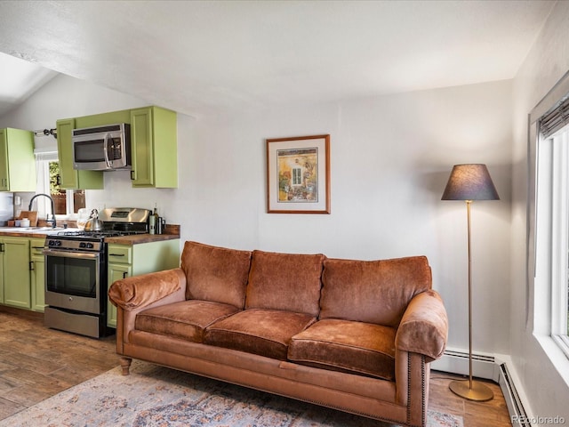 3134 W Center Ave, Denver, CO 80219 - living room with dark wood finished floors, lofted ceiling, and a baseboard heating unit