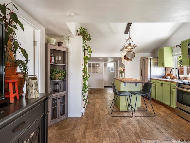 3134 W Center Ave, Denver, CO 80219 - kitchen featuring green cabinets, a sink, stainless steel appliances, dark wood finished floors, and lofted ceiling