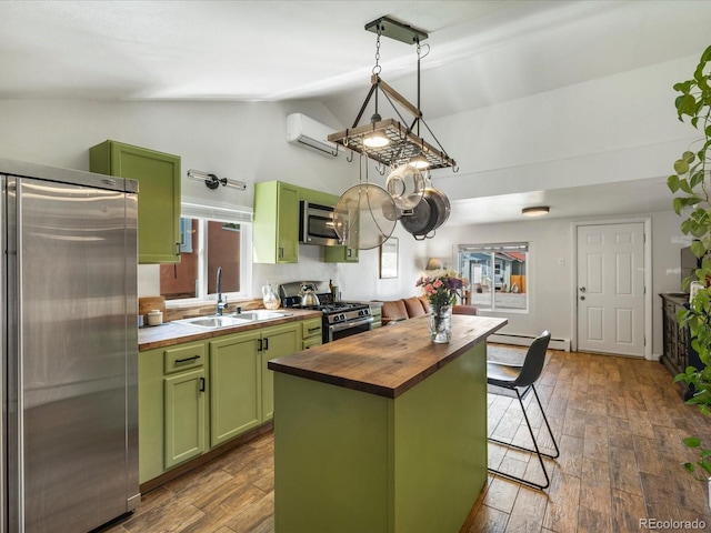 3134 W Center Ave, Denver, CO 80219 - kitchen with green cabinetry, butcher block counters, stainless steel appliances, a sink, and a wall mounted AC