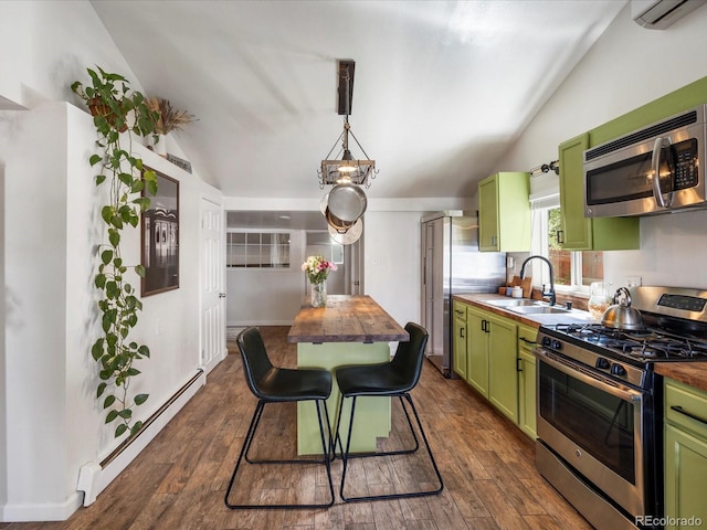 3134 W Center Ave, Denver, CO 80219 - kitchen with green cabinets, appliances with stainless steel finishes, a sink, butcher block countertops, and vaulted ceiling