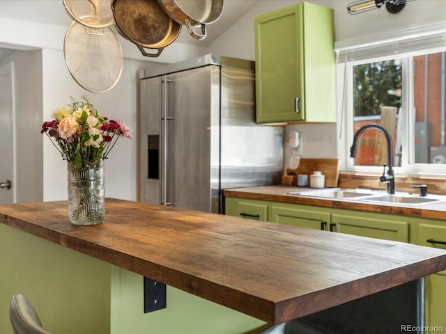 3134 W Center Ave, Denver, CO 80219 - kitchen with butcher block counters, green cabinets, and stainless steel refrigerator with ice dispenser