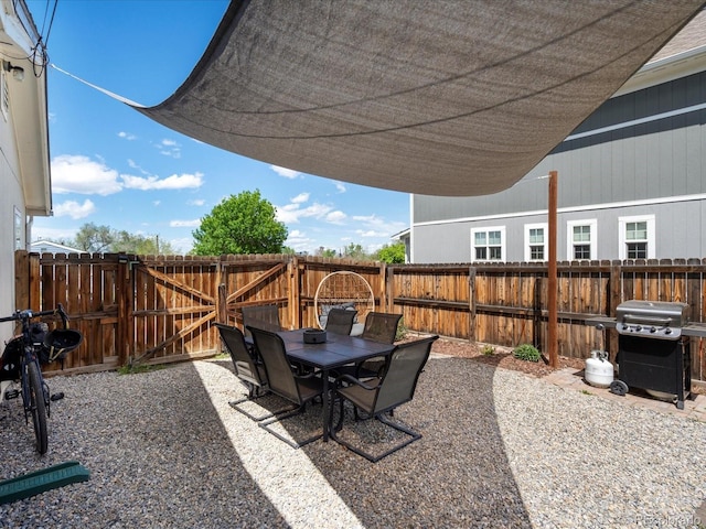 3134 W Center Ave, Denver, CO 80219 - fenced backyard featuring area for grilling, a patio area, a gate, and outdoor dining area