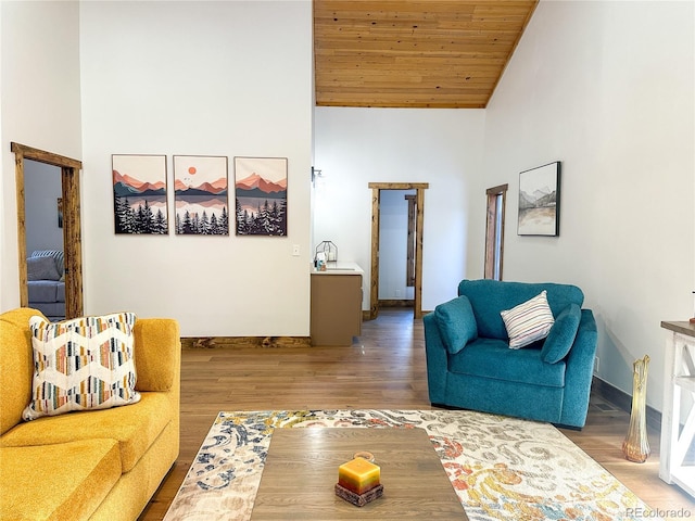 living room featuring hardwood / wood-style floors, high vaulted ceiling, and wooden ceiling