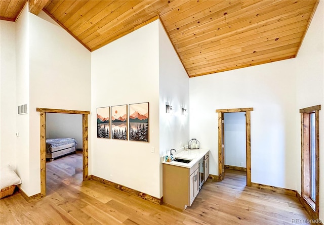 hall featuring light wood-type flooring, wooden ceiling, and high vaulted ceiling